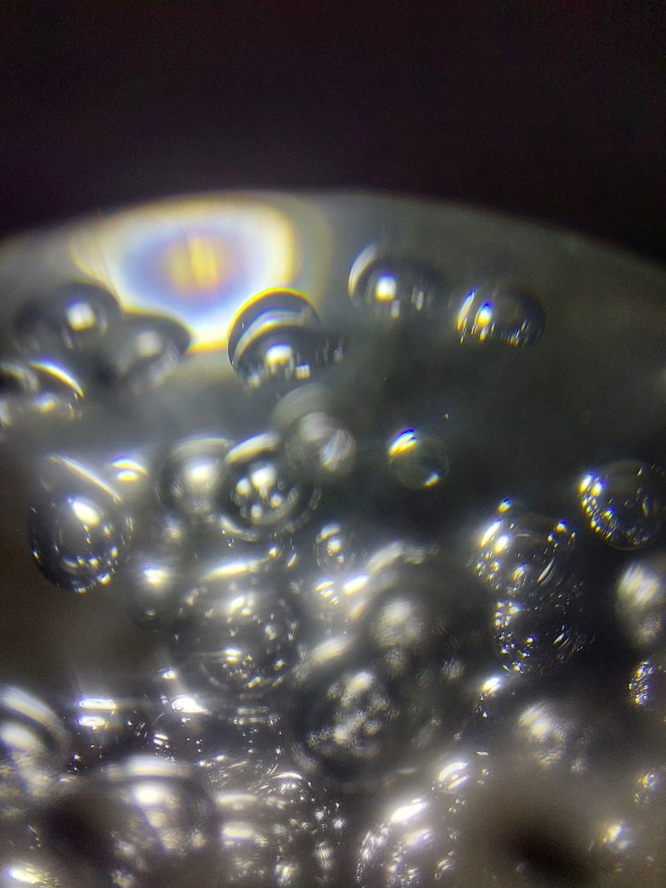 FULL FRAME SHOT OF WATER DROPS ON ILLUMINATED SURFACE