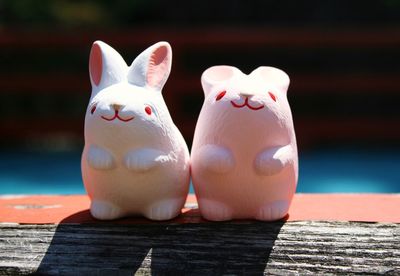 Stuffed toys arranged on wooden shelf for sale at market