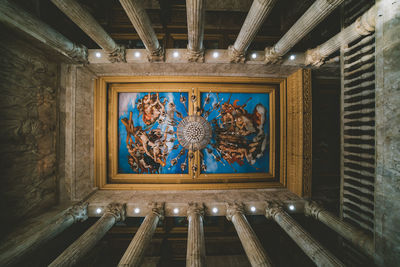 Low angle view of stained glass on ceiling of building