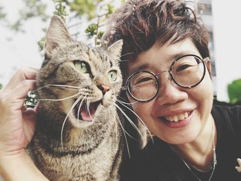 Portrait of smiling woman with cat