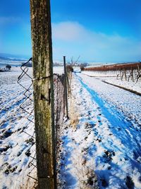 Scenic view of snow covered field against sky