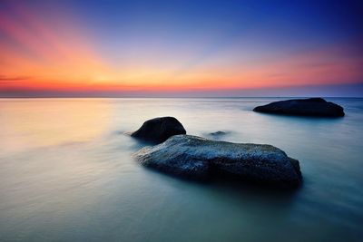 Scenic view of sea against sky at sunset