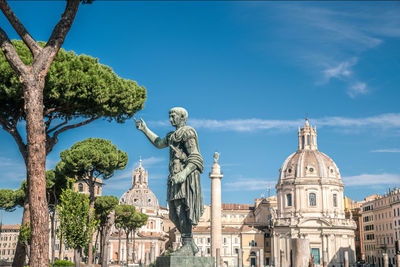 Low angle view of statue against blue sky