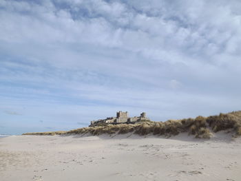 View of beach against cloudy sky