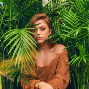 Portrait of young woman amidst plants