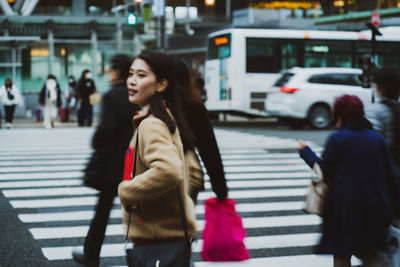 Young woman walking on city street