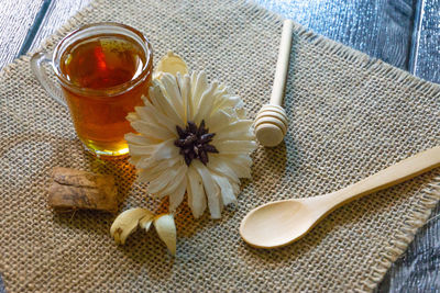 High angle view of glass of white rose on table