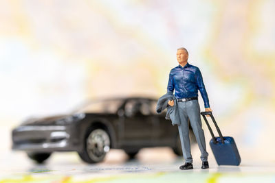 Portrait of man standing in car