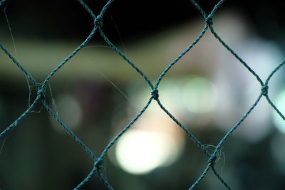 Close-up of chainlink fence against blurred background