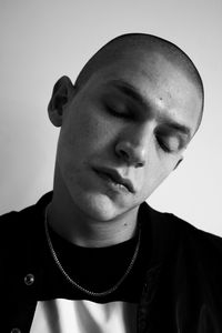 Close-up portrait of young man against white background