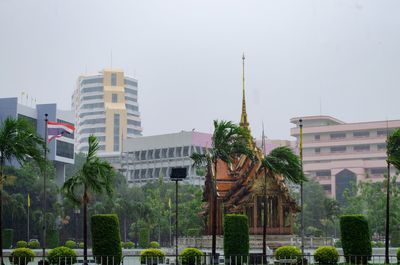 Buildings in city against clear sky