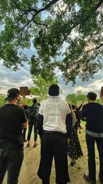 Rear view of people against sky