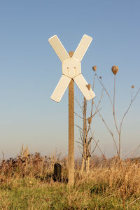 Cross on field against clear sky