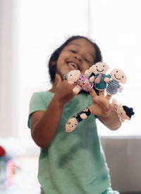 Girl holding toy at home