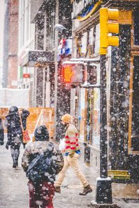 People walking on street in city during winter