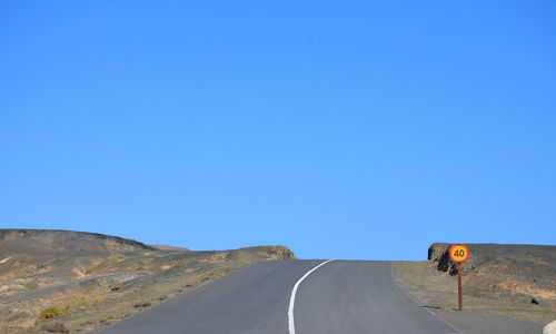 Empty road on the volcanic landscape of fuerteventura