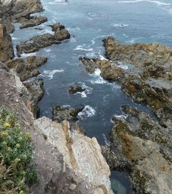 High angle view of rocks at sea shore