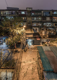 High angle view of illuminated street amidst buildings in city