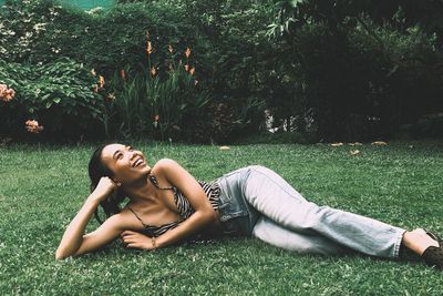 Young woman lying on field