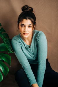 Portrait of woman sitting at home