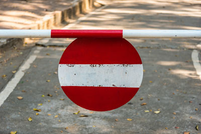 Close-up of red umbrella on road