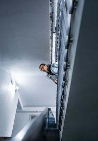 Man bending over stairs