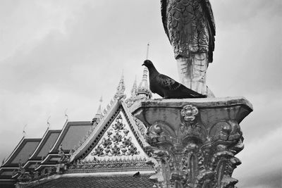Low angle view of statue against sky
