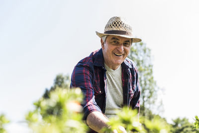 Portrait of smiling senior man in garden