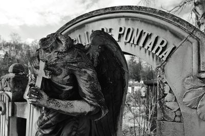 Broken statue at cemetery