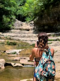 Rear view of woman looking at waterfall