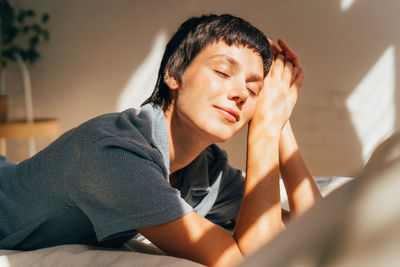 Portrait of young woman sitting at home