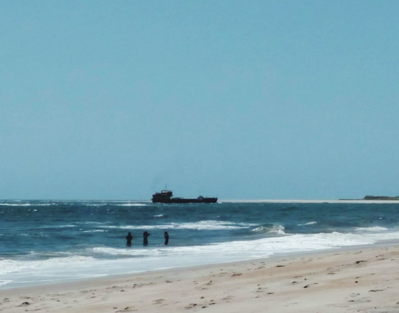 sea, beach, horizon over water, water, shore, clear sky, sand, copy space, nautical vessel, transportation, wave, mode of transport, boat, scenics, tranquil scene, nature, beauty in nature, tranquility, surf, blue