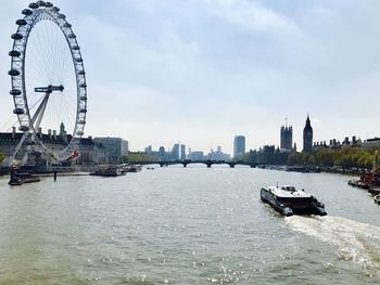 Ship sailing on river in city