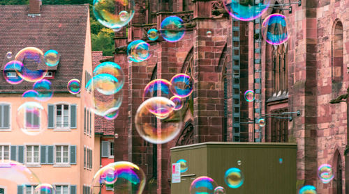 Digital composite image of bubbles against building