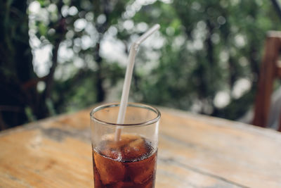 Close-up of iced cola on table