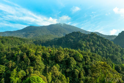 Scenic view of mountains against cloudy sky