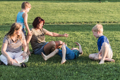 Group of people sitting on grass