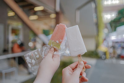 Cropped hand of person holding food