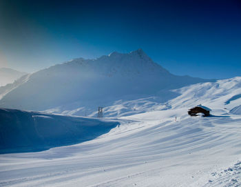 Scenic view of snowcapped mountains against clear sky