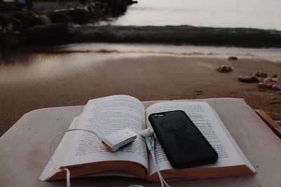 Close-up of open book on beach