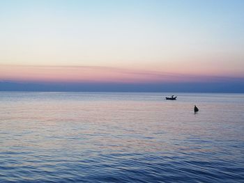 Scenic view of sea against sky at sunset