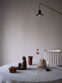 Various objects on table against wall