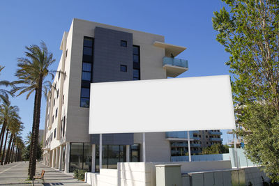 Low angle view of buildings against clear blue sky