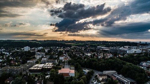 High angle shot of townscape against sky at sunset