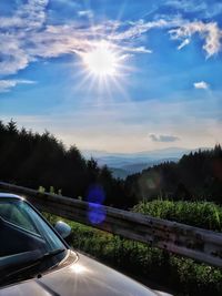 Road amidst trees against sky during sunset