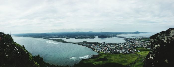 High angle view of sea and cityscape against sky