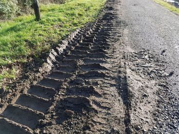 High angle view of tire tracks on road