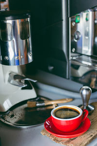 Close-up of drink by coffee maker on table