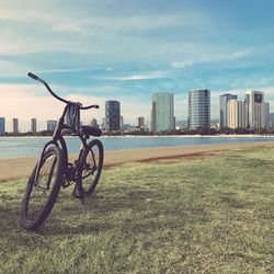 Bicycle parked by sea in city