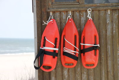 Red floats hanging from lifeguard hut at beach